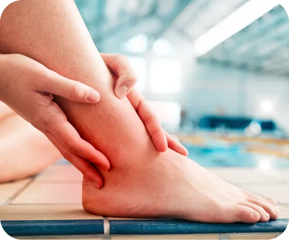 Person touching the outer side of the ankle showing pain and inflammation caused by peroneal tendonitis or peroneal split tear