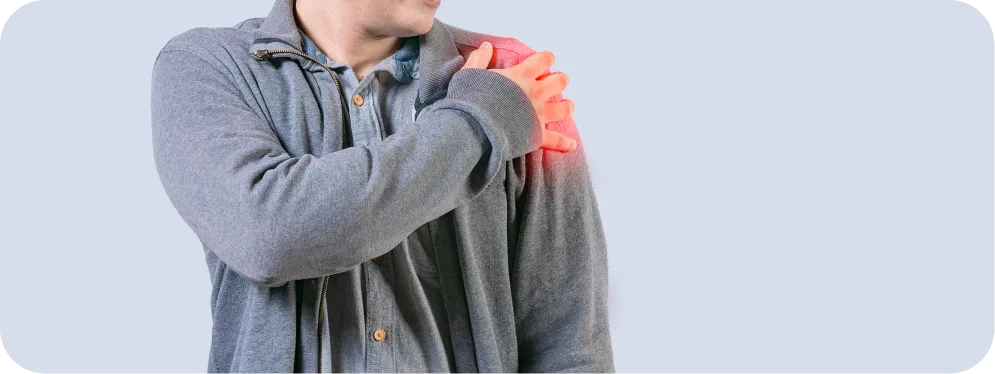 Man holding his shoulder due to anterior shoulder pain from biceps tendon subluxation