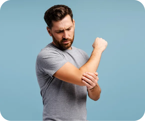 Man touching his elbow due to pain from a biceps tendon partial tear