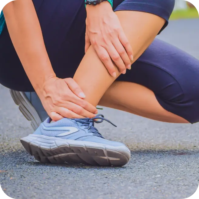 Athlete holding ankle in pain, indicating possible cartilage injury or osteochondral lesion