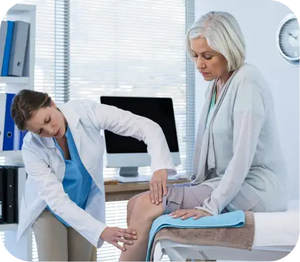 Orthopedic specialist examining a patient’s knee during meniscus tear evaluation and treatment consultation