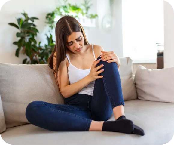 Person holding their knee due to pain caused by a meniscus root tear