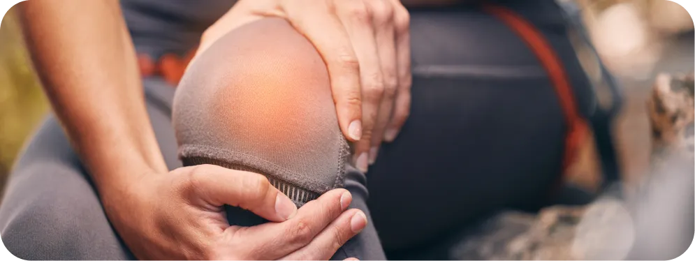 Close-up of a person holding their knee with visible irritation, illustrating pain and pressure caused by Lateral Patellofemoral Compressive Syndrome