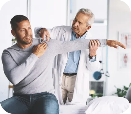 Orthopedic doctor examining a patient’s shoulder and arm during evaluation and treatment planning for a clavicle (collarbone) fracture