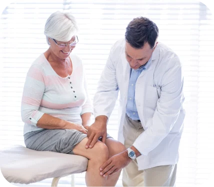 Orthopedic specialist examining a patient’s knee during evaluation for Posterolateral Corner (PLC) and MCL injuries