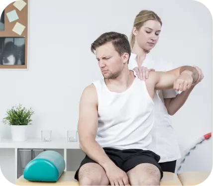 Physical therapist performing a shoulder stability assessment on a patient during evaluation for a posterior labral tear