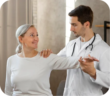 Orthopedic specialist assisting a patient with shoulder movement during evaluation and recovery from a rotator cuff tear