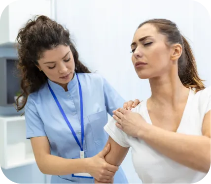 Healthcare professional examining a patient’s painful shoulder during evaluation for rotator cuff partial tears, PASTA lesions, tendinosis, or calcific tendinitis