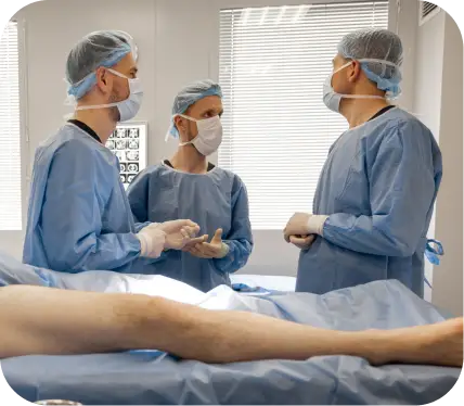 Surgeons reviewing meniscus repair options during knee surgery preparation