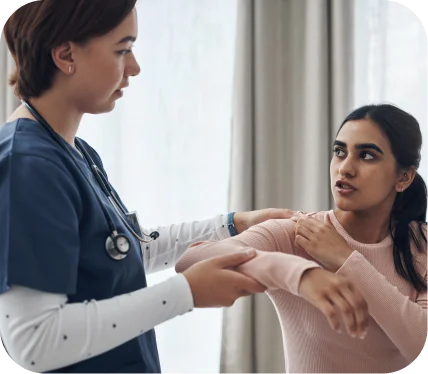 Woman receiving orthopedic shoulder evaluation for suspected AC joint injury