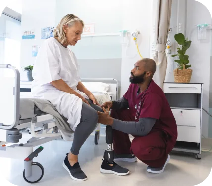 Orthopedic clinician assisting older patient during recovery after a subchondral femur or tibial fracture treated with Subchondroplasty